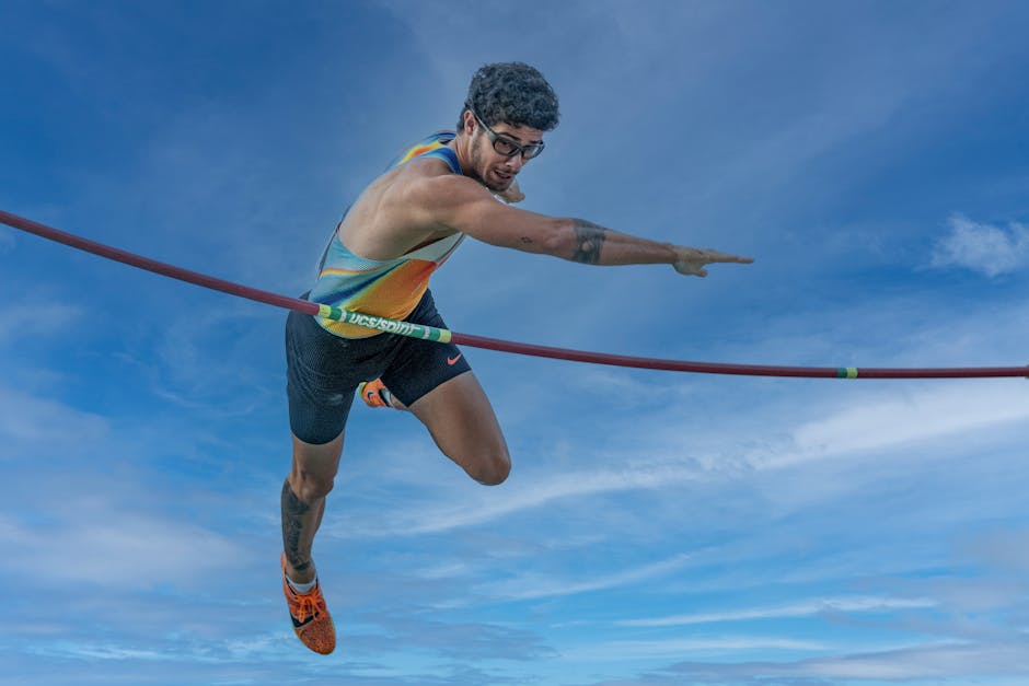 High-energy capture of a pole vaulter in action against a vibrant sky
