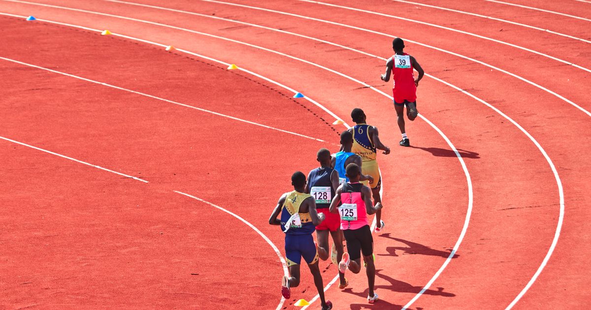 Athletes competing on an outdoor track at a competitive meet