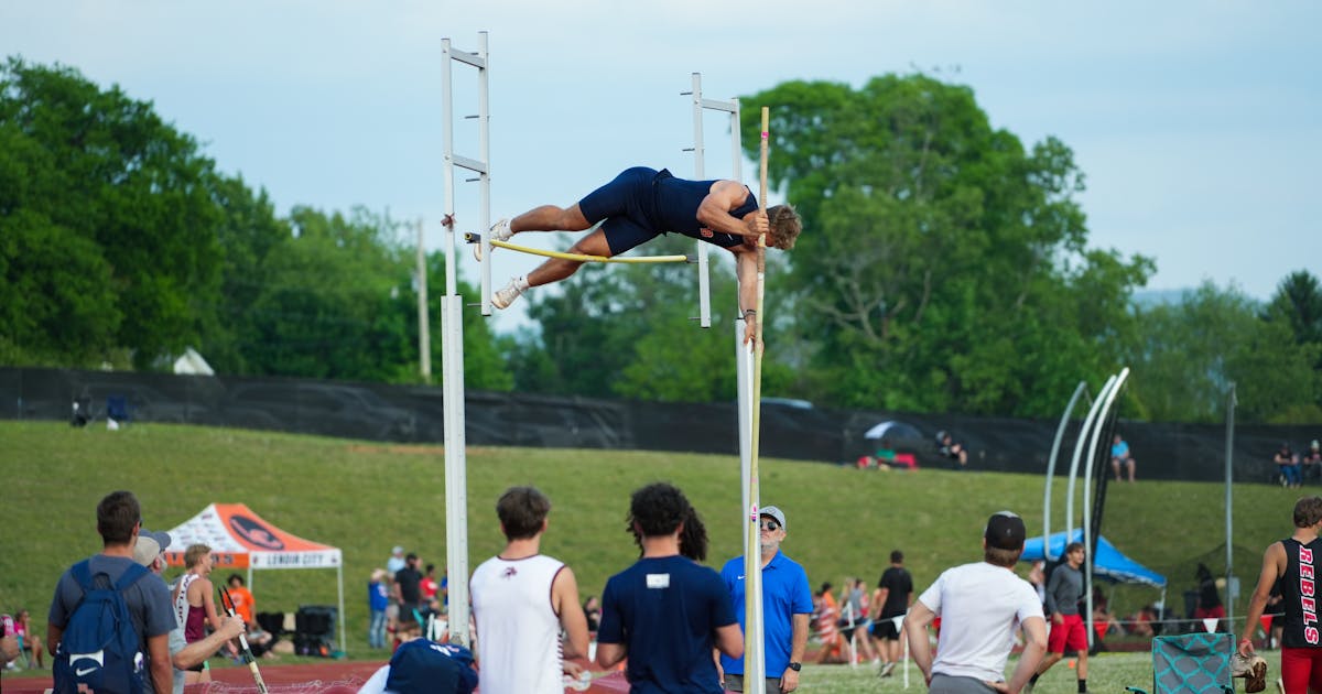 Athlete competing in a pole vault event with landing pit visible
